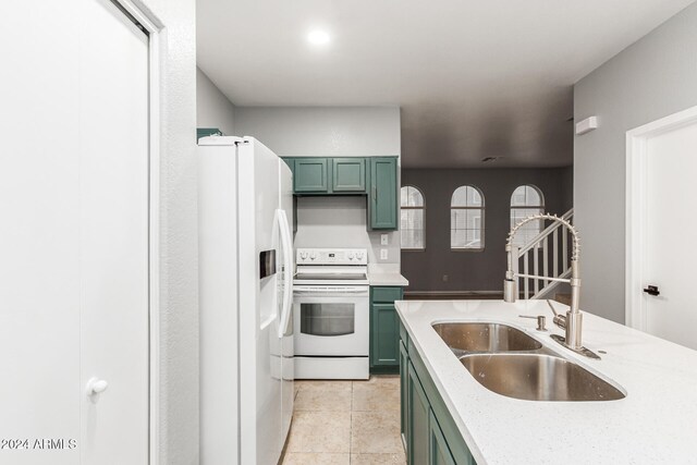 kitchen featuring light tile patterned flooring, sink, white appliances, green cabinets, and light stone countertops