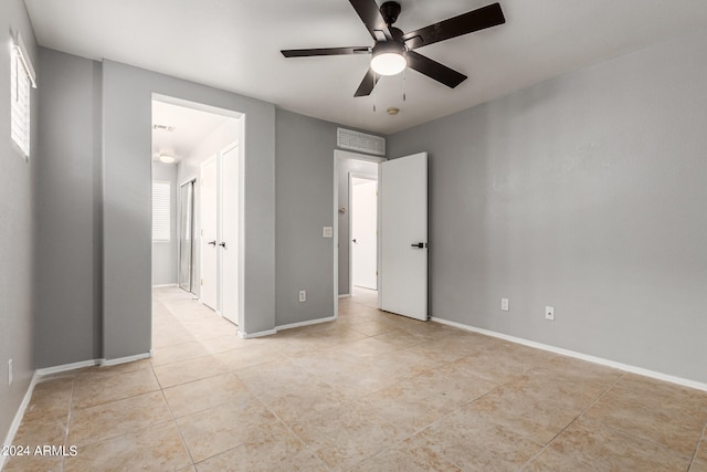 unfurnished bedroom with light tile patterned floors and ceiling fan