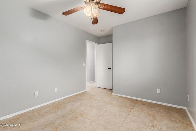 tiled empty room with ceiling fan