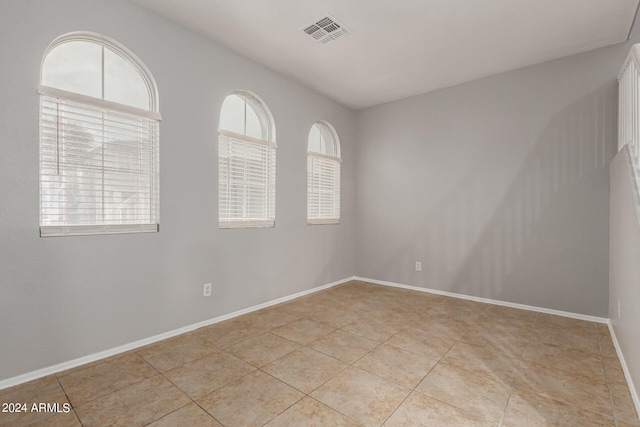 unfurnished room with light tile patterned floors