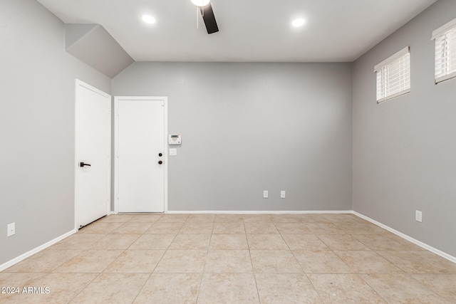 tiled empty room featuring ceiling fan