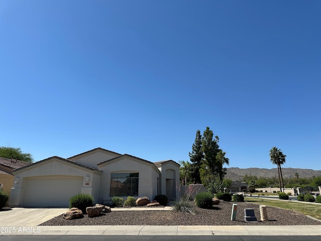 2013 E Valencia Dr, Phoenix, AZ 85042 - ranch-style home with an attached garage, a mountain view, concrete driveway, and stucco siding