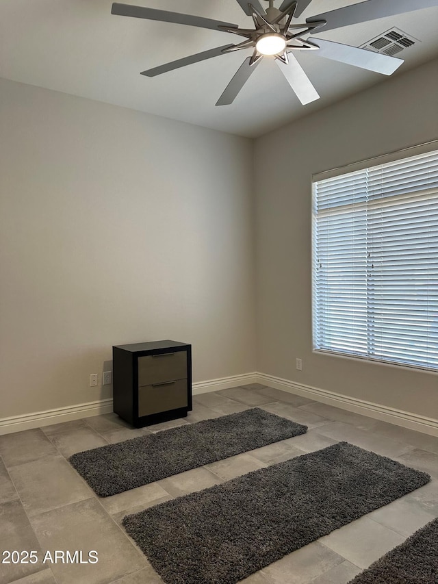 2013 E Valencia Dr, Phoenix, AZ 85042 - spare room with ceiling fan, baseboards, and tile patterned floors