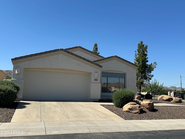 2013 E Valencia Dr, Phoenix, AZ 85042 - ranch-style home featuring stucco siding, an attached garage, and concrete driveway