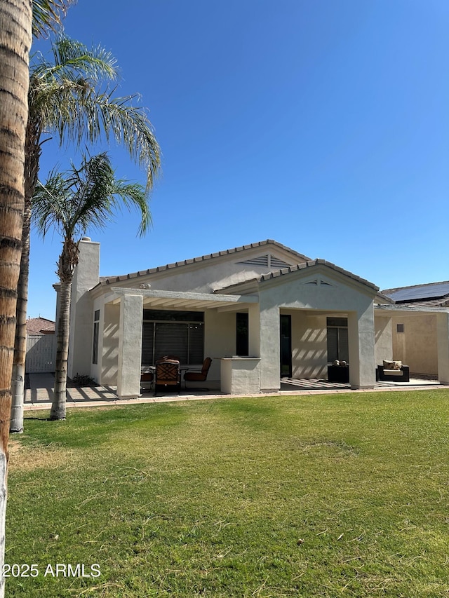 2013 E Valencia Dr, Phoenix, AZ 85042 - rear view of house with a patio area, stucco siding, a yard, and outdoor lounge area