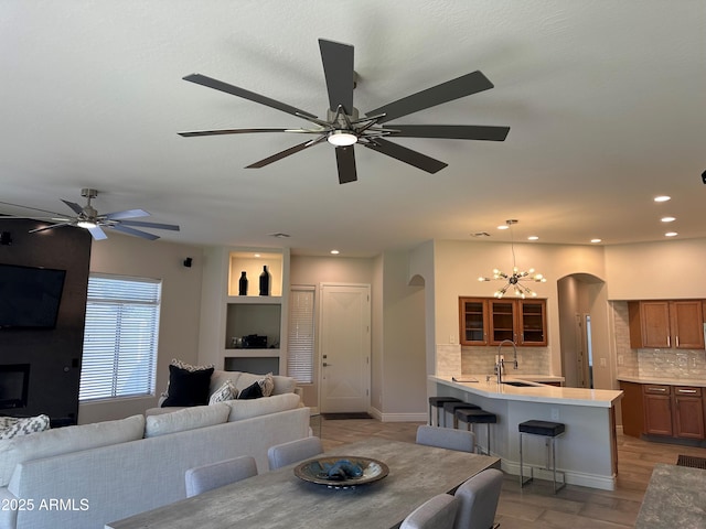 2013 E Valencia Dr, Phoenix, AZ 85042 - dining room featuring arched walkways, ceiling fan, recessed lighting, and a chandelier