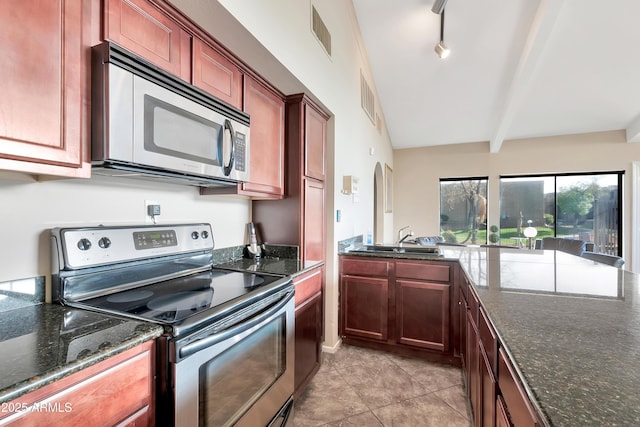 3825 E Camelback Rd Unit 182, Phoenix, AZ 85018 - kitchen with appliances with stainless steel finishes, light tile patterned flooring, dark stone countertops, and beam ceiling