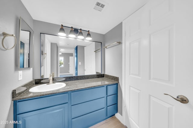 3825 E Camelback Rd Unit 182, Phoenix, AZ 85018 - bathroom with vanity and wood finished floors