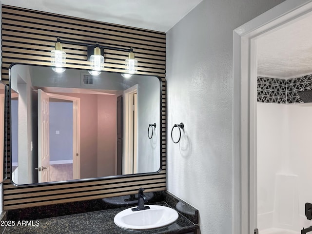 3825 E Camelback Rd Unit 182, Phoenix, AZ 85018 - bathroom with vanity and a textured wall