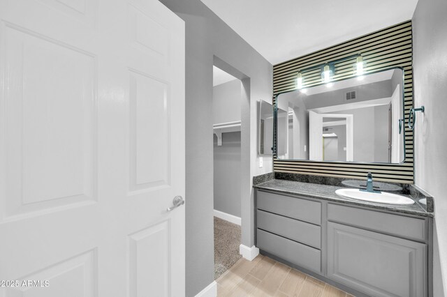 3825 E Camelback Rd Unit 182, Phoenix, AZ 85018 - bathroom with vanity and baseboards