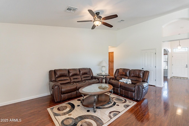 living room featuring ceiling fan, dark hardwood / wood-style floors, and high vaulted ceiling