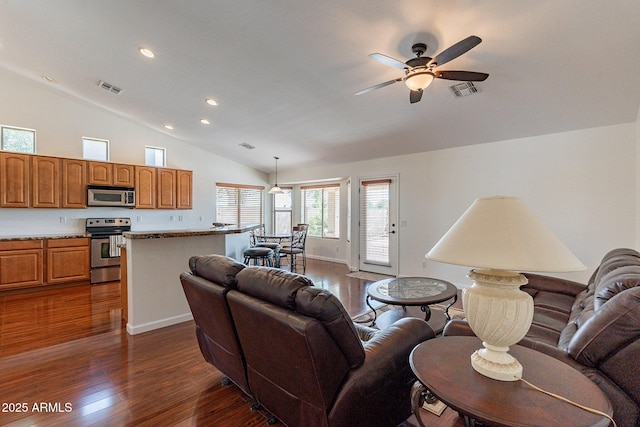 living room with ceiling fan, lofted ceiling, and dark hardwood / wood-style flooring