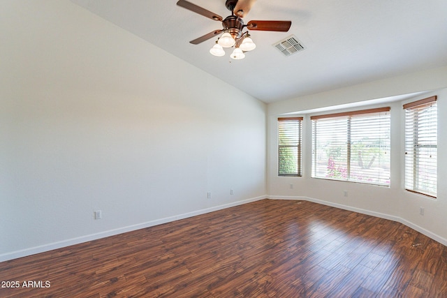 unfurnished room with dark wood-type flooring, a wealth of natural light, ceiling fan, and vaulted ceiling