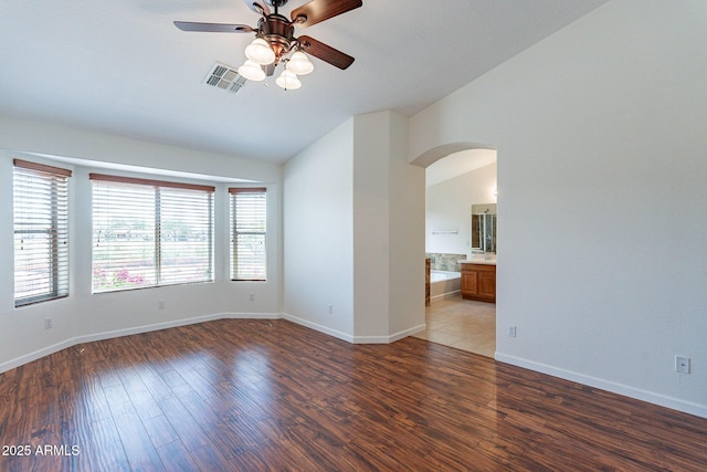 spare room featuring dark wood-type flooring, ceiling fan, and lofted ceiling