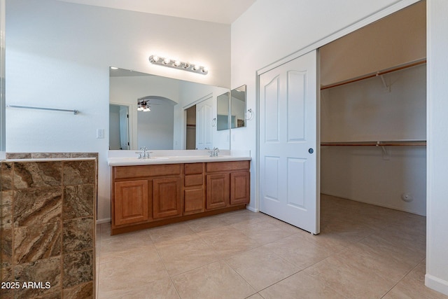 bathroom featuring tile patterned flooring, vanity, and ceiling fan