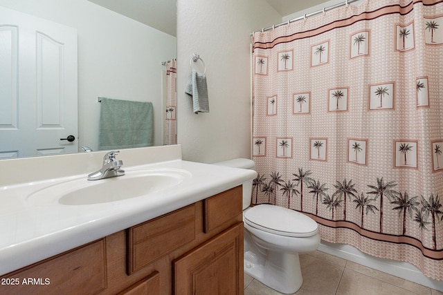 bathroom featuring tile patterned flooring, vanity, and toilet