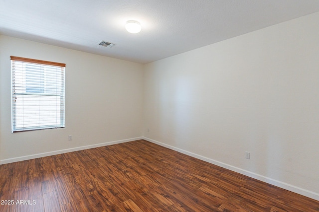 empty room with dark wood-type flooring