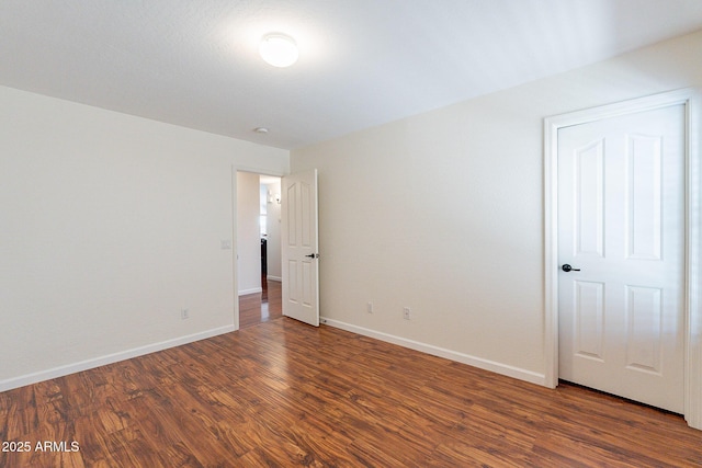 unfurnished room featuring dark hardwood / wood-style flooring