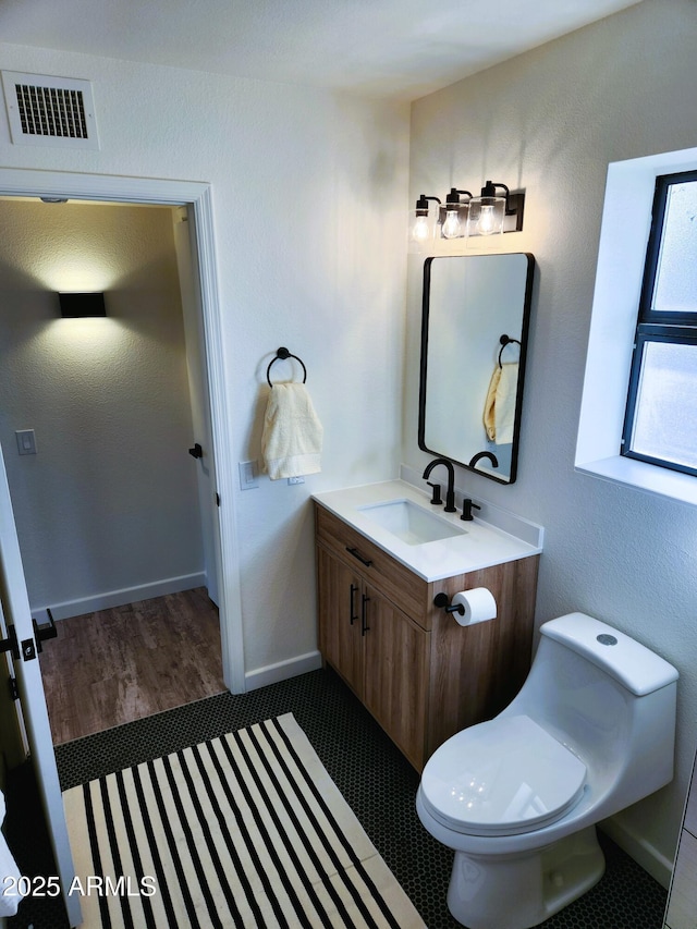 bathroom with vanity and toilet