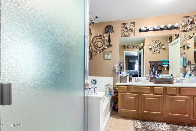 bathroom featuring vanity, tile patterned flooring, and a washtub