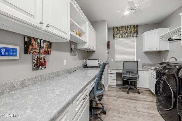 interior space featuring cabinets, ceiling fan, washer / dryer, and light hardwood / wood-style floors