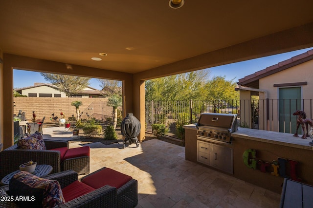 view of patio featuring exterior kitchen, outdoor lounge area, and area for grilling