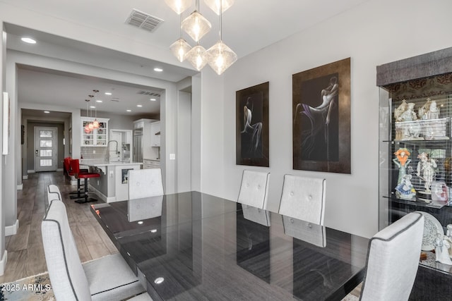 dining room with dark hardwood / wood-style floors and sink