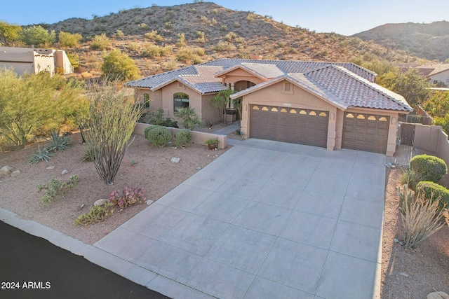 view of front of home with a mountain view and a garage