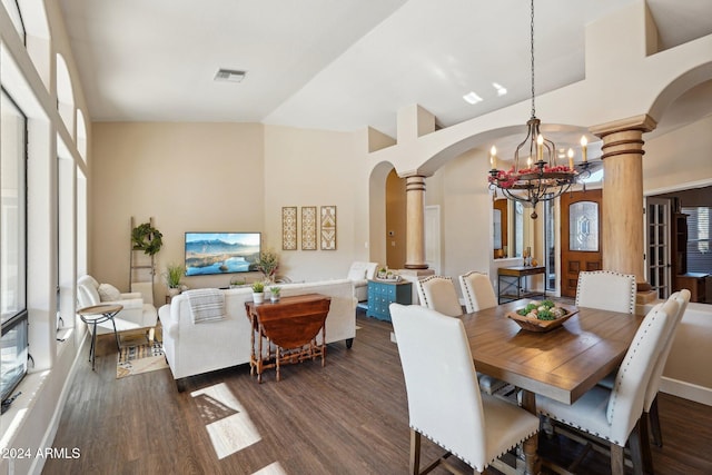 dining area with ornate columns, high vaulted ceiling, a chandelier, and dark hardwood / wood-style floors