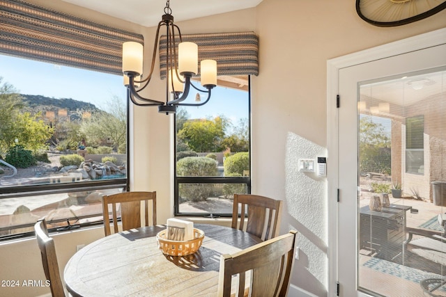 dining space featuring a mountain view and a notable chandelier