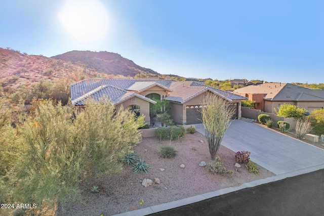 view of front of home featuring a mountain view and a garage