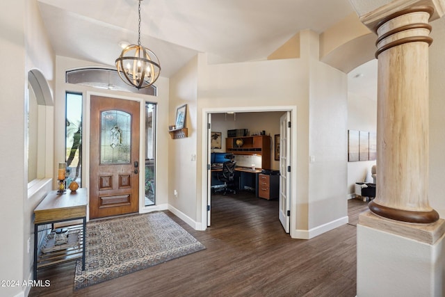 foyer with ornate columns, dark hardwood / wood-style flooring, and a notable chandelier