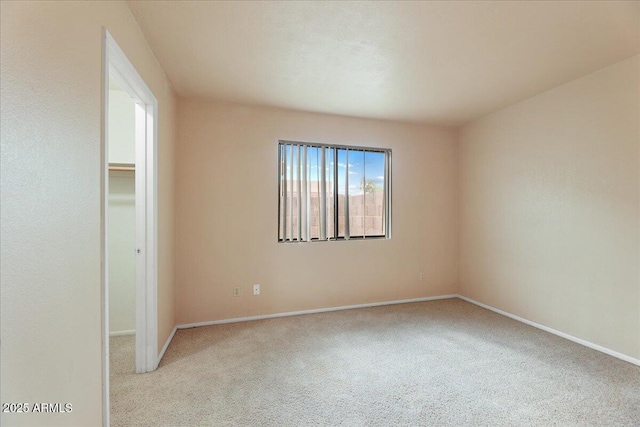 carpeted spare room with baseboards