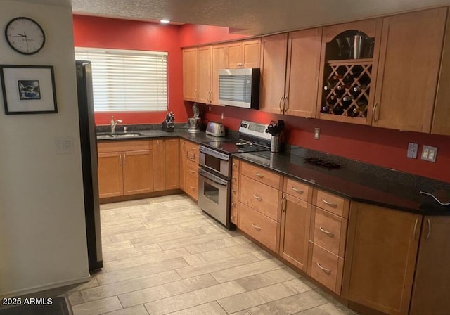 3924 E Cortez St, Phoenix, AZ 85028 - kitchen featuring stainless steel appliances, dark countertops, and a textured ceiling