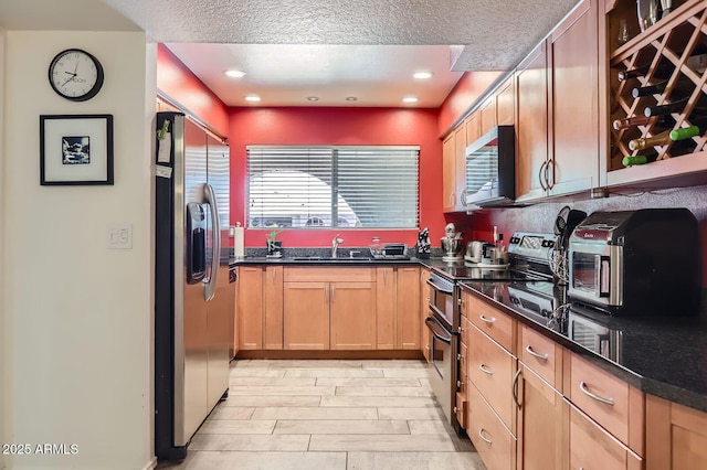 3924 E Cortez St, Phoenix, AZ 85028 - kitchen featuring appliances with stainless steel finishes, a textured ceiling, light wood-style floors, recessed lighting, and light brown cabinets