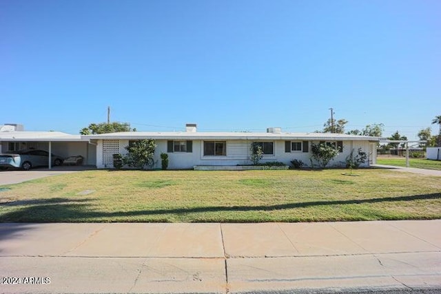 ranch-style home with a front yard and a carport