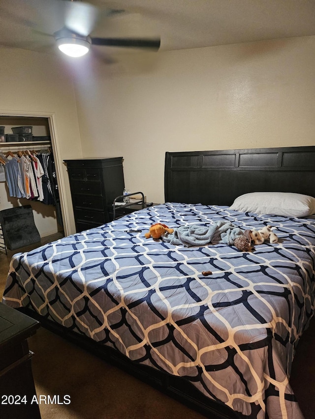 bedroom with ceiling fan and a closet