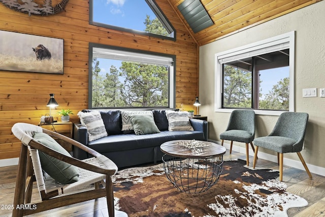 living room with wood walls, vaulted ceiling, and hardwood / wood-style floors