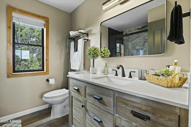 bathroom with walk in shower, toilet, vanity, and hardwood / wood-style flooring