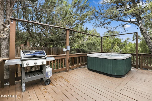 deck featuring a hot tub and a grill