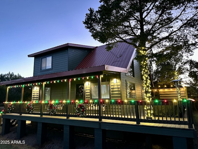 property exterior at dusk with covered porch