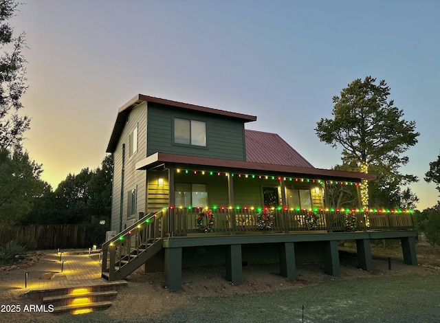 back house at dusk with a wooden deck