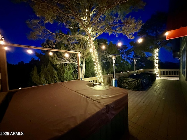 patio at night with a hot tub