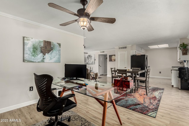 office with crown molding, ceiling fan, and light hardwood / wood-style floors