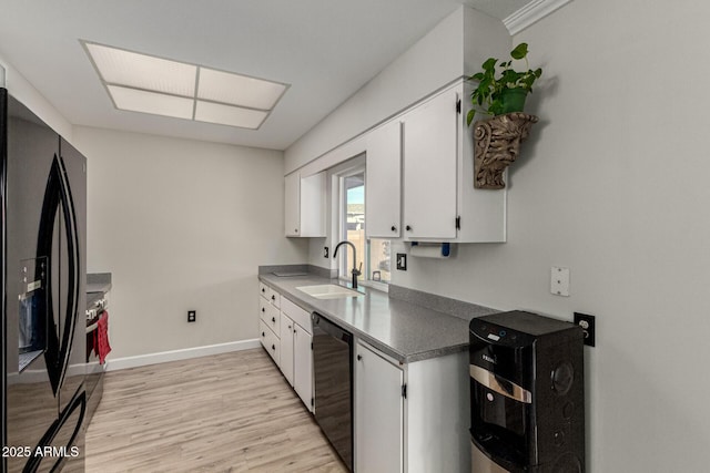 kitchen with sink, light hardwood / wood-style flooring, black appliances, and white cabinets