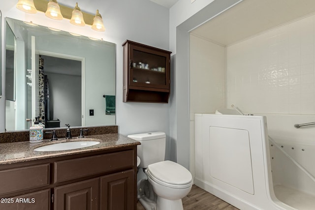 bathroom featuring vanity, toilet, and hardwood / wood-style floors