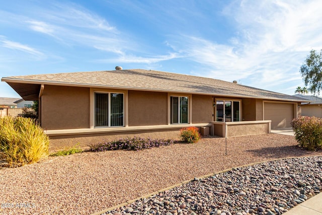 rear view of property featuring a garage