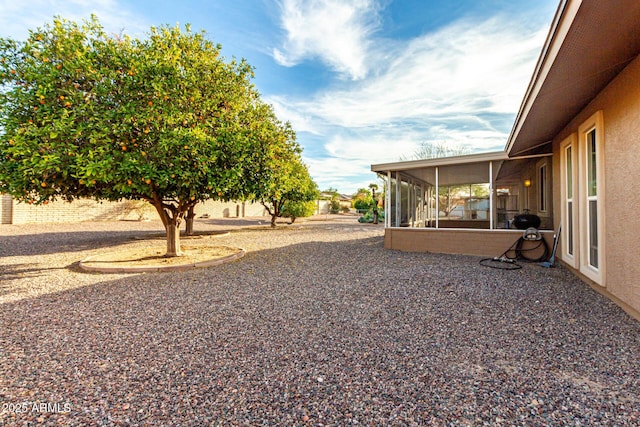 view of yard with a sunroom