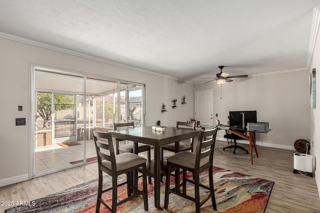 dining area featuring crown molding, light hardwood / wood-style floors, and ceiling fan