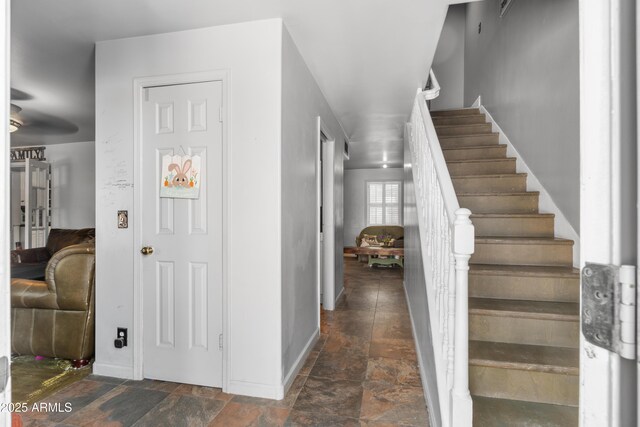 entrance foyer with stairway and stone finish flooring